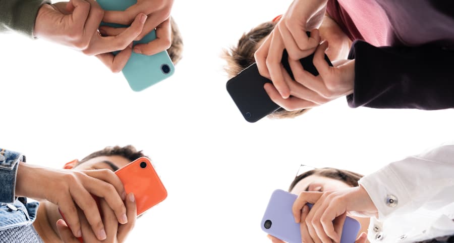 Teenagers using smartphones to access social media sites in New Haven